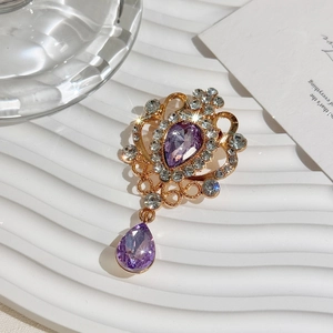 Vintage gold-plated crystal brooch with teardrop purple stones and sparkling rhinestones