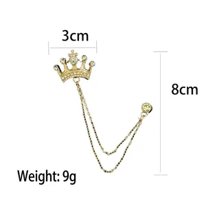 Men's crown brooch pin with gold finish, crystals, and dual chain tassels for suits