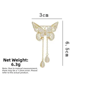 Detailed view of golden butterfly brooch with pearls and tassels, size 3cm by 6.5cm