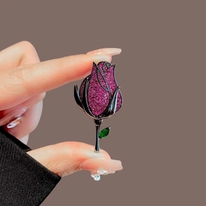 Elegant rose brooch with pink zircons and green gemstone in vintage European palace style