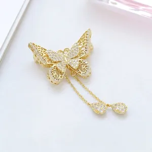 Golden butterfly brooch with hollow wings, rhinestones and elegant long tassels