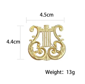 Classic harp brooch in matte gold finish with intricate embossed relief and sizing details