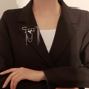 Silver star and moon pin brooch with multi-layer tassel chains on black blazer lapel