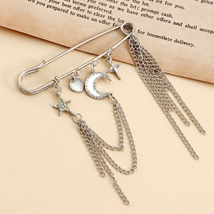 Detail view of silver star and moon brooch with hanging fringe chains and crystal charms