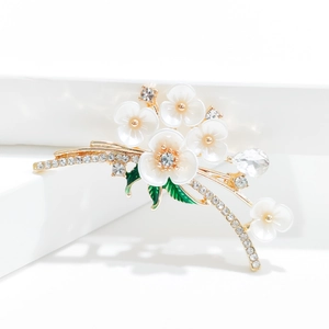 Elegant floral enamel brooch with cream petals, gold finish and sparkling rhinestones