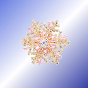 Elegant rotating snowflake brooch with pink gemstones and crystals on golden metal base