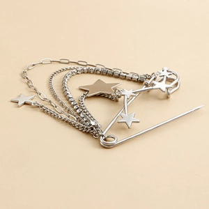Macro view of silver star brooch with layered chains and sparkling rhinestones