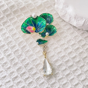 Elegant lotus leaf enamel brooch with pearls and teardrop crystal on white background