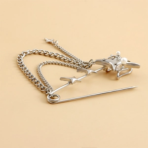 Detail of silver star brooch with pearl, rhinestones and double metal hanging chains