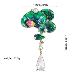 Detailed close-up of green lotus brooch with pearls, crystals and size dimensions