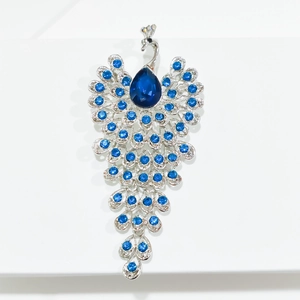 Elegant silver peacock brooch with ocean blue crystals and a teardrop main stone