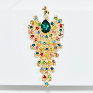 Peacock brooch in gold-tone metal with multi-color rhinestones and a large green crystal
