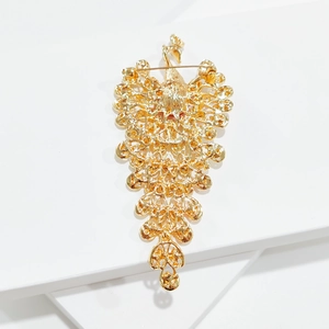 Detailed view of the gold-plated peacock brooch back showing hollow craft and safety pin