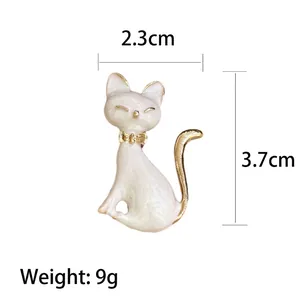 Fashionable white enamel cat brooch with golden bow tie, size 2.3cm by 3.7cm