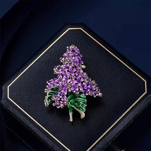 Elegant purple lilac flower brooch in enamel with green leaves on black jewelry box