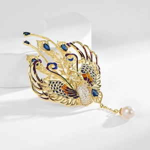 Exquisite gold phoenix brooch with colorful enamel wings and a hanging pearl pendant