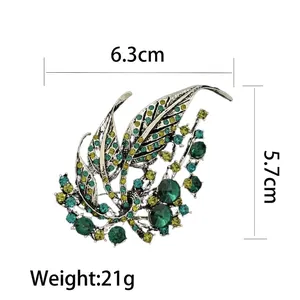 Elegant silver leaf brooch with green crystals measuring 6.3cm by 5.7cm for women