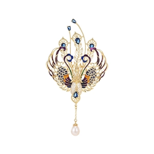 Peacock brooch with blue crystals, enamel wings and a hanging pearl on a gold frame