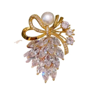 Elegant ribbon bow brooch with crystal marquise zircon and pearl on white background