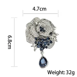 Elegant silver rose brooch with blue crystals and a teardrop pendant for women