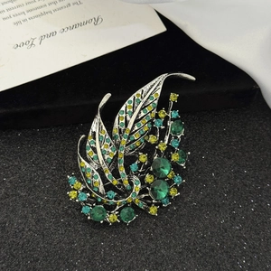Elegant hollow leaf brooch with multicolored green rhinestones on a silver base