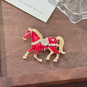 Exquisite red enamel horse brooch with sparkling rhinestones and gold-plated finish