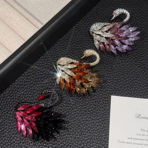 Exquisite crystal swan brooch with gradient rhinestones for women set on leather background