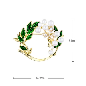 Detail view of enamel flower brooch with white pearls and 35mm by 42mm size markings