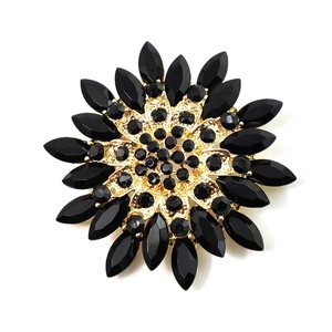 Elegant gold and black crystal magnolia flower brooch with radiant petal design