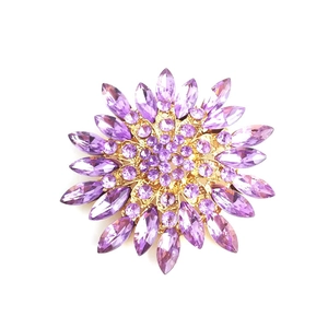 Elegant magnolia flower crystal brooch with purple stones in a luxurious gold setting