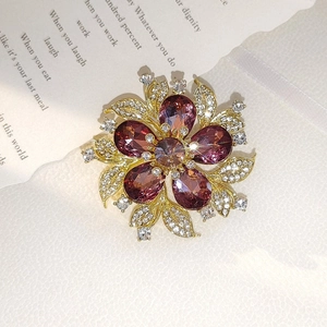 Exquisite gold floral brooch with purple teardrop crystals and micro-set cubic zirconia detail