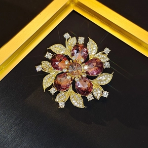Exquisite gold floral brooch with purple pear-cut crystals and white zircon accents