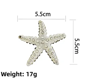 Close-up of tropical starfish brooch featuring white enamel and sparkling rhinestones