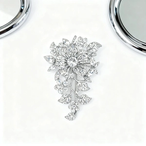 Detail of silver floral brooch with shimmering crystals and elegant petal design