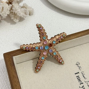 Elegant starfish brooch with multi-color rhinestones and bronze metallic finish