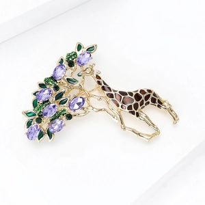 Detailed close-up of a golden giraffe brooch with purple crystals and green leaves