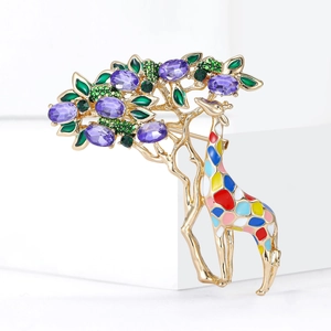 Detailed close-up of a golden giraffe brooch with purple crystals and colorful enamel