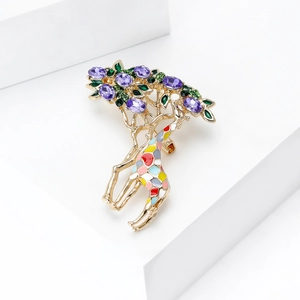 Detailed view of a giraffe brooch with purple crystals and colorful enamel accents