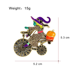 Halloween witch riding bicycle with pumpkin brooch pin, vintage gold finish with rhinestones