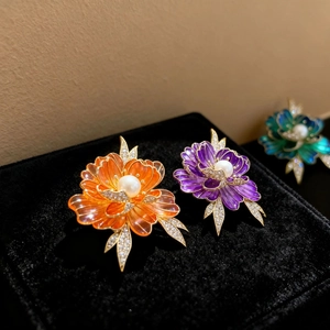Vintage enamel peony flower brooch with vibrant petals and pearl center on velvet box