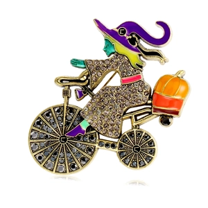 Halloween witch riding bicycle with pumpkin brooch pin featuring crystal rhinestones