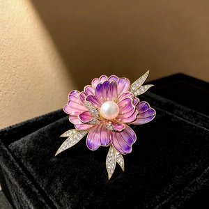 Detailed close-up of vintage enamel peony brooch with pink petals and a pearl center