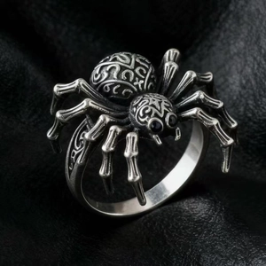 Vintage silver spider ring with gothic geometric engraving on black leather background