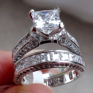 Luxurious silver ring set with princess cut zircon center stone and channel-set diamonds