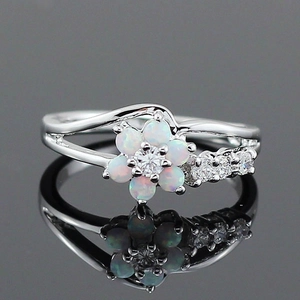 Elegant opal flower ring with zircon accents on a polished silver band with reflection