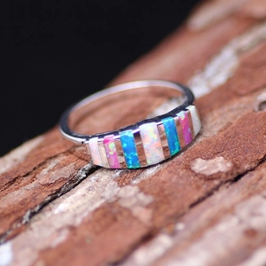Exquisite silver opal ring with rectangular white, blue and pink stones on bark