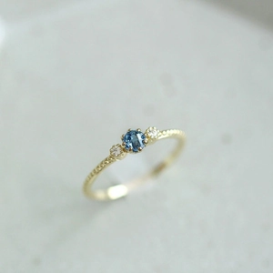 Vintage 18k gold plated ring with round blue gemstone and side diamonds for engagement