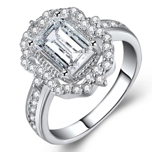 Rose gold plated ring featuring emerald cut cubic zirconia with halo pavé setting