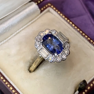 Vintage gold plated ring featuring oval blue zircon and surrounding crystal accents