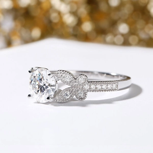 Macro side view of bow-knot ring featuring round center stone and pave diamond accents